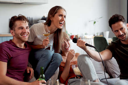 Friends having karaoke and drinking alcoholの写真素材