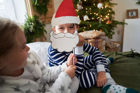 Kids playing at Christmas morning togetherの写真素材