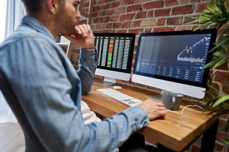 Adult man following stock market data