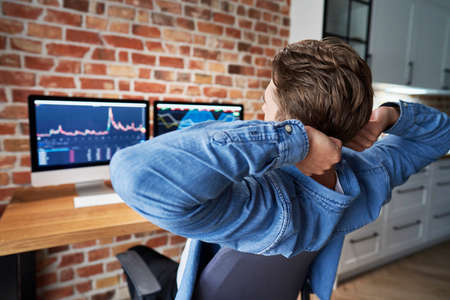 Young adult man stretching during the working about finances