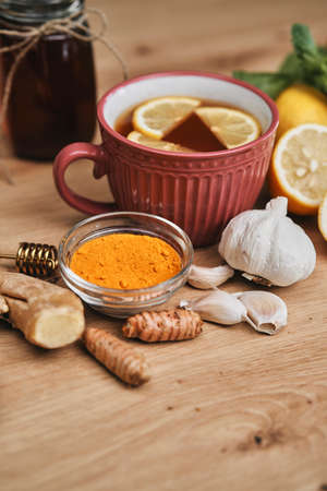 Warming up tea and natural antioxidants on wooden deskの写真素材