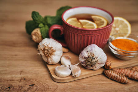 Winter tea and natural antioxidants on wooden deskの写真素材
