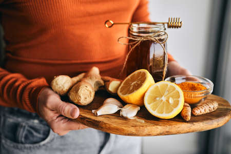 Unrecognizable woman holding a desk full of natural antioxidantsの写真素材