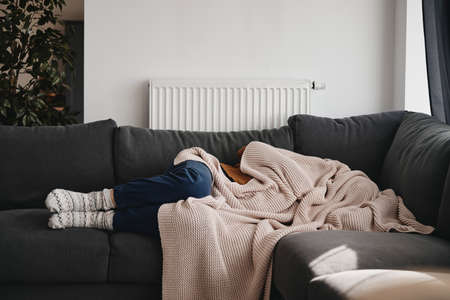 Woman sleeping under the blanketの写真素材