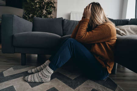 Sitting woman has serious problemsの写真素材