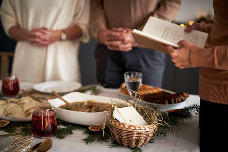 Close up of family praying in Christmas Eve