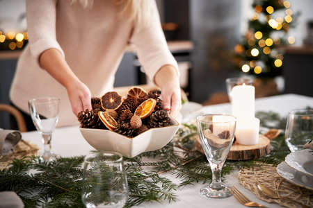 Close up of women preparing table for Christmas Eve