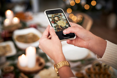 Woman making photo of Christmas's tableの写真素材