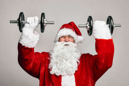Santa Claus with large dumbbellsの写真素材