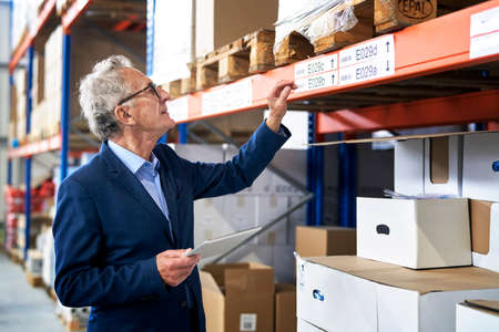 Caucasian leader in mature age working at warehouseの写真素材