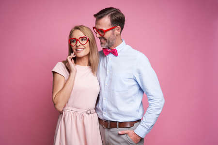 Caucasian couple at Valentine's Day posing on pink backgroundの写真素材