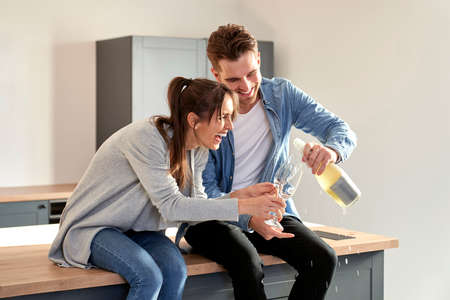 Couple celebrating house ownership with a champagne