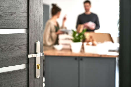 Blurred caucasian couple packing some kitchen stuffの写真素材