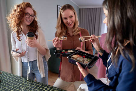 Group of women has brake in tailor's workshopの写真素材