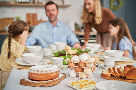 Caucasian family of four celebrating over easter tableの写真素材