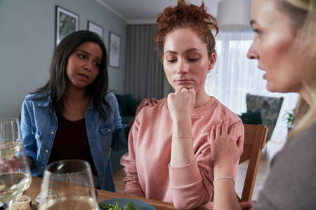 Three female caucasian friends chatting over problems at home