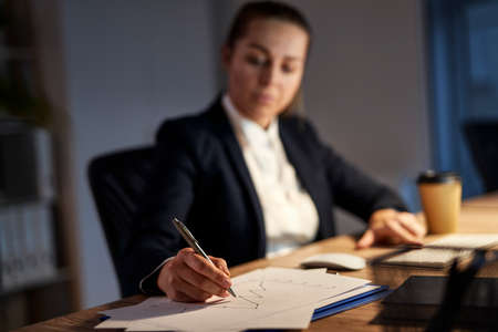 Close up of woman completes the documents in the officeの写真素材