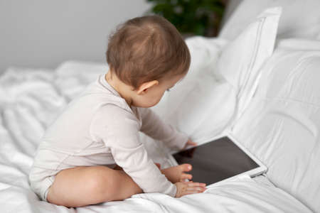 Caucasian little girl with digital tablet at homeの写真素材