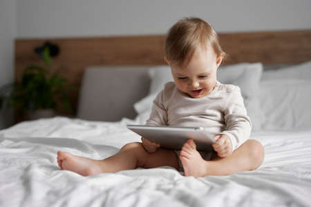 Caucasian little girl using digital tablet at homeの写真素材