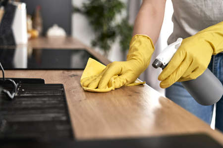Close up of caucasian woman cleaning kitchen at home