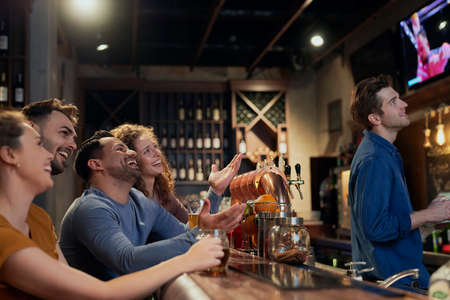 Group of friends watching match in the pubの写真素材
