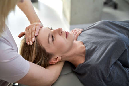 Female physical therapist massaging her patient