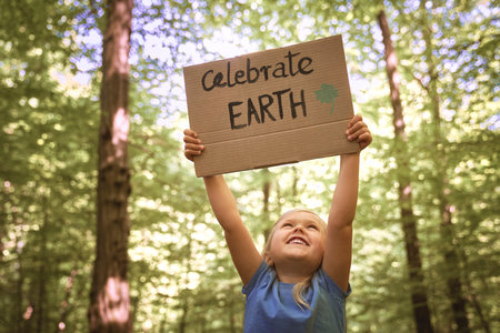 Little caucasian girl holding the poster about caring planetの写真素材