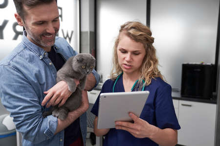 Female vet showing the medical tests on the tablet