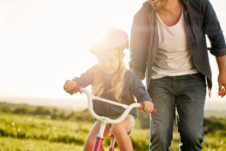 Close up of caucasian toddler learning how to ride bikeの写真素材