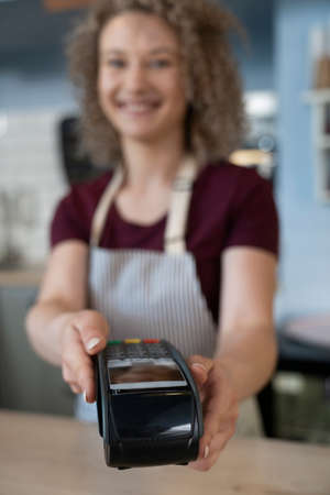 Unrecognizable woman giving a credit card readerの写真素材