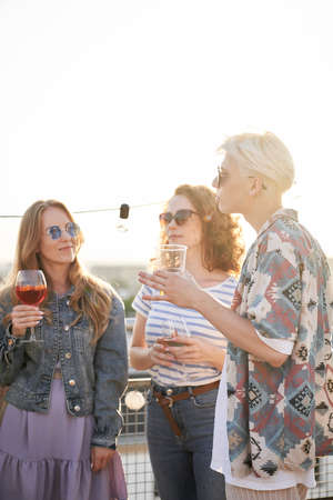 Caucasian friends talking together at the party in top of the roof