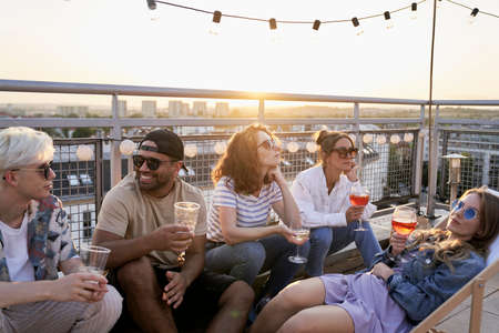 Group of multi ethnicity friends at the party in top of the roofの写真素材