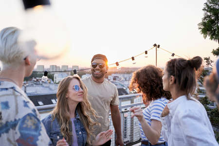 Group of multi ethnicity friends dancing at the party in top of the roofの写真素材