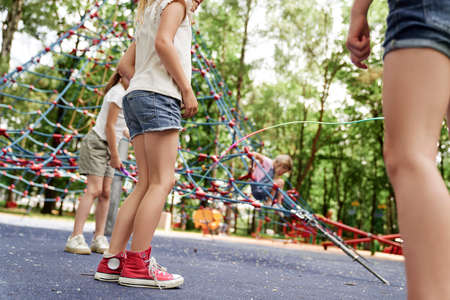 Low section of girls playing together at playgroundの写真素材