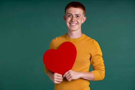 Caucasian teenage boy with heart shape speech bubbleの写真素材