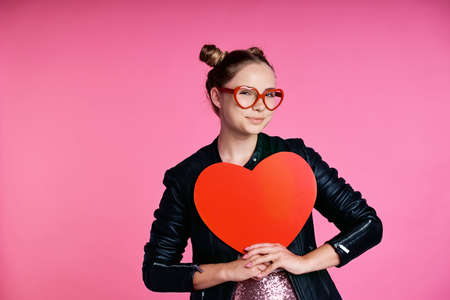 Caucasian teenage girl with heart shape speech bubble and red glassesの写真素材