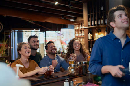 Cheering friends of soccer fans in the pub