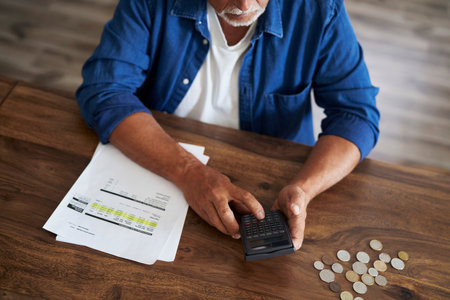 From above senior man counting home budget at the calculator. Documents prepare special for shoot.の写真素材