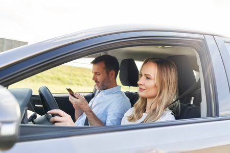 Caucasian adult woman driving a car with her husband
