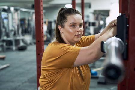 Caucasian woman with overweight standing at the gym