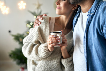 Close up of couple standing at home at Christmas time and looking awayの写真素材