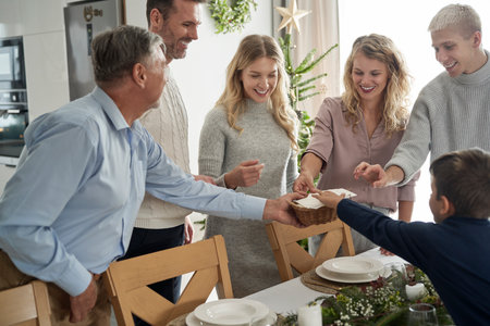 Caucasian family sharing wafer during the Christmas Eveの写真素材