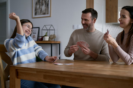 Caucasian family playing in card at homeの写真素材