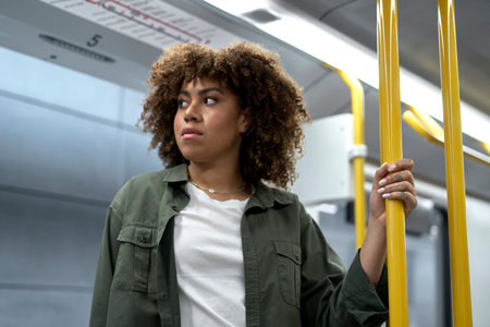 Young afro woman traveling by undergroundの写真素材