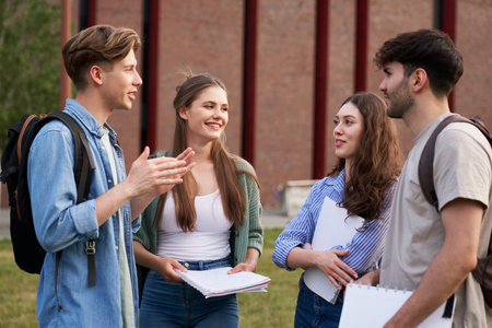 Group of caucasian students standing at university campus and chatting