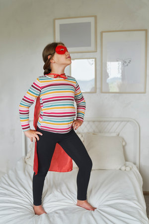 Caucasian girl playing a role of superhero in the costumeの写真素材