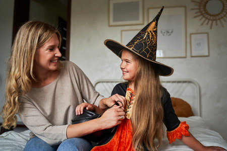 Caucasian mother and daughter preparing before Halloween partyの写真素材