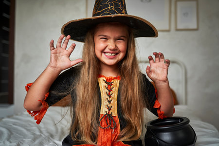 Portrait of elementary age girl wearing witch costumeの写真素材