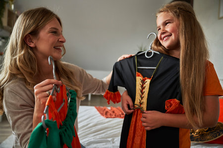 Caucasian mother and daughter preparing before Halloween partyの写真素材