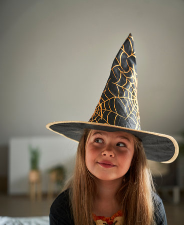 Elementary age girl wearing witch costumeの写真素材